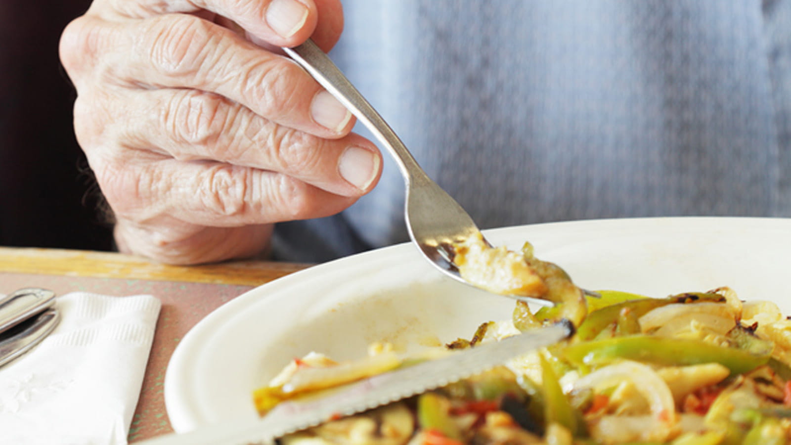 Es wird von einem Teller Nudeleintopf gegessen